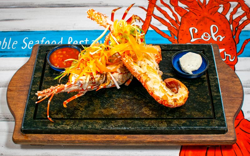 PalmBeach Tropical Restaurant | Pink LobStar Grill (price per 100 grams) | (min. 500g), cooked on the grill and served with crioula sauce and sour salad. According to availability and sold by weight