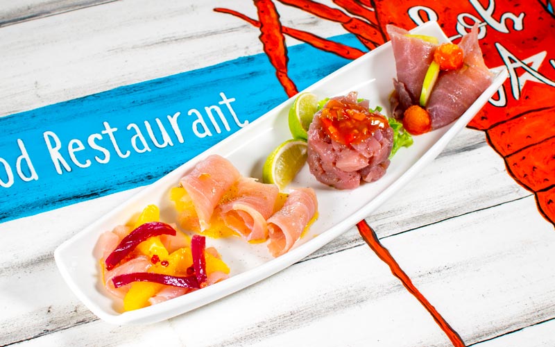 PalmBeach Tropical Restaurant | Poker of the Ocean Flavors | Tuna Tartare with Lime +<br>Amberjack Carpaccio Marinated in Orange and Pink Pepper +<br>Smoked Tuna Ham +<br>Sliced Marinated Amberjack with Pineapple