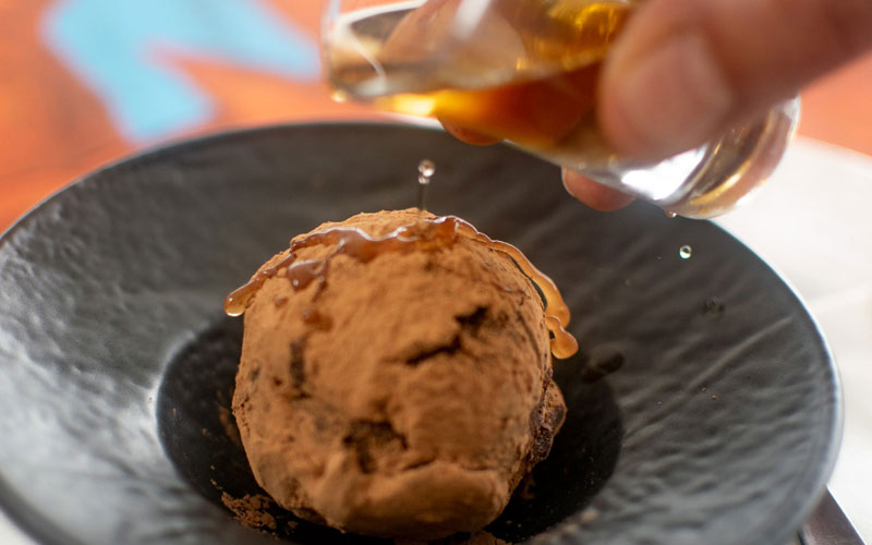 PalmBeach Tropical Restaurant | CiocoRum | dark chocolate sphere with almonds and rum, covered with cocoa powder and served with a shot of Havana 7 rum